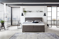 Boxspringbett Rodin – schmal zulaufendes Kopfteil, Kunstleder Dunkelbraun – Frontalansicht | Betten Deluxe